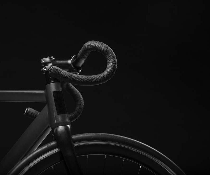 Black bicycle handlebars and wheel.