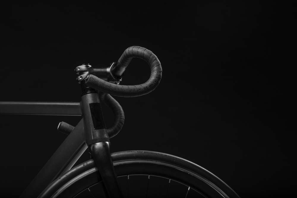 Black bicycle handlebars and wheel.