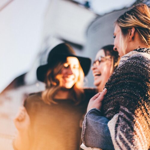 Happy women laughing together outdoors.